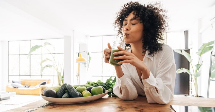 woman drinking green juice